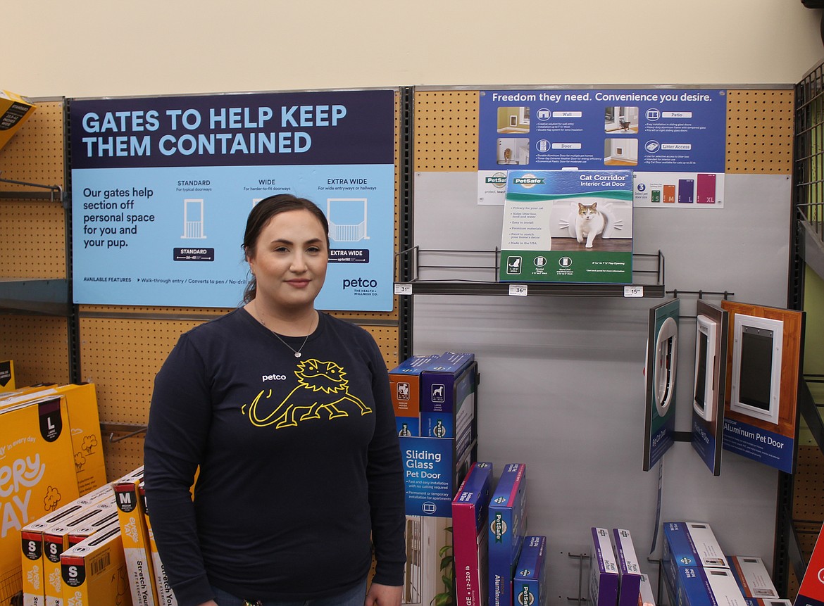 Stephanie Waters, manager of Petco in Moses Lake, stands with the store’s display of pet doors. There are plenty of options out there for giving pets access to the great outdoors with a wide range of price options and finishes, she said.