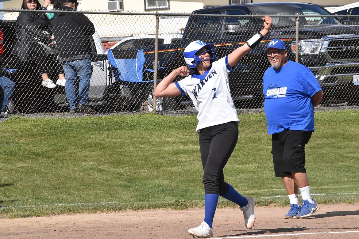 Warden High School senior Kiana Rios (1) celebrates as she rounds third base to home plate after hitting the ball over the fence. That home run was also the 10th run for Warden, triggering the 10-run mercy rule and ending the game. Warden Head Coach Randy Wright smiles in the background.