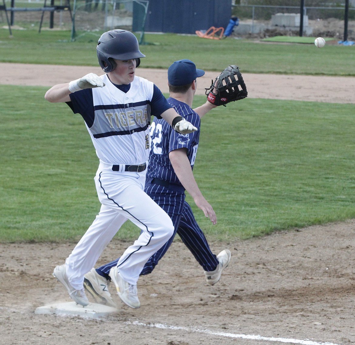 JASON ELLIOTT/Press
Timberlake's Ty Gallimore runs down the first base line to beat a throw from the Bonners Ferry shortstop during Wednesday's 3A District 1 baseball championship game at Timberlake High.