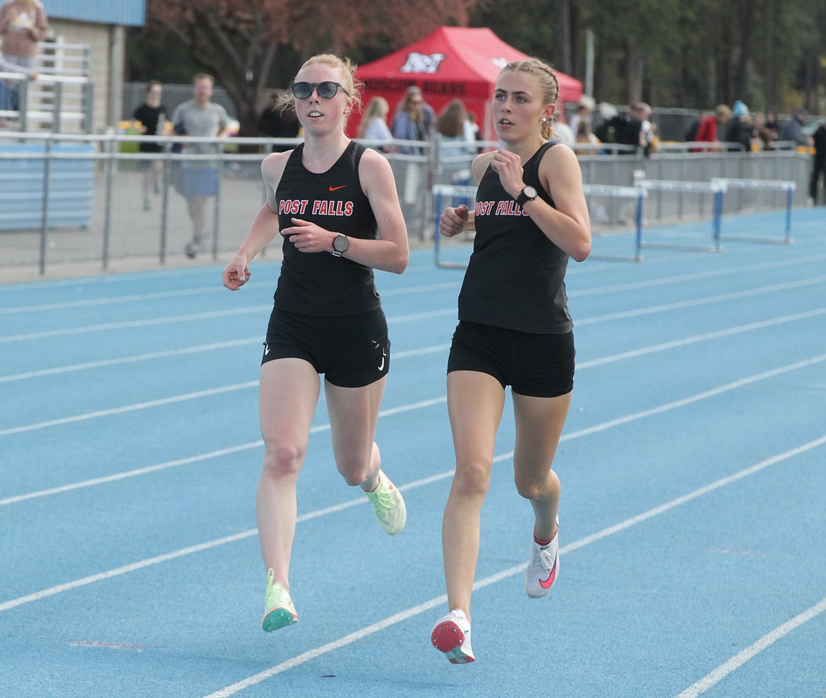 JASON ELLIOTT/Press
Post Falls senior Sammie Wood, left, passes fellow Trojan Annastasia Peters on the sixth lap of the girls 3,200-meter run at the 5A Region 1 meet at Coeur d'Alene High on Thursday. Wood won the race in 10 minutes, 37.42 seconds.