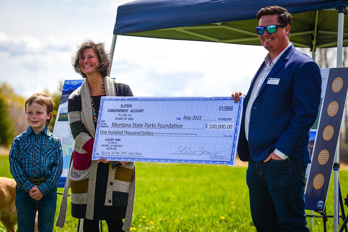 A check is presented from the Sliter family to the Montana State Parks Foundation during a ribbon-cutting ceremony at Somers Beach State Park on Thursday, May 12. (Casey Kreider/Daily Inter Lake)