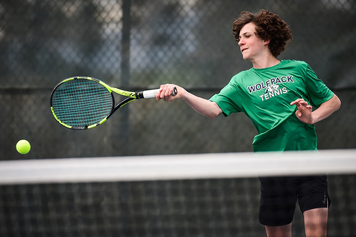 Glacier's Will Rudbach hits a return against Flathead's Kutuk White at Flathead Valley Community College on Thursday, May 12. (Casey Kreider/Daily Inter Lake)