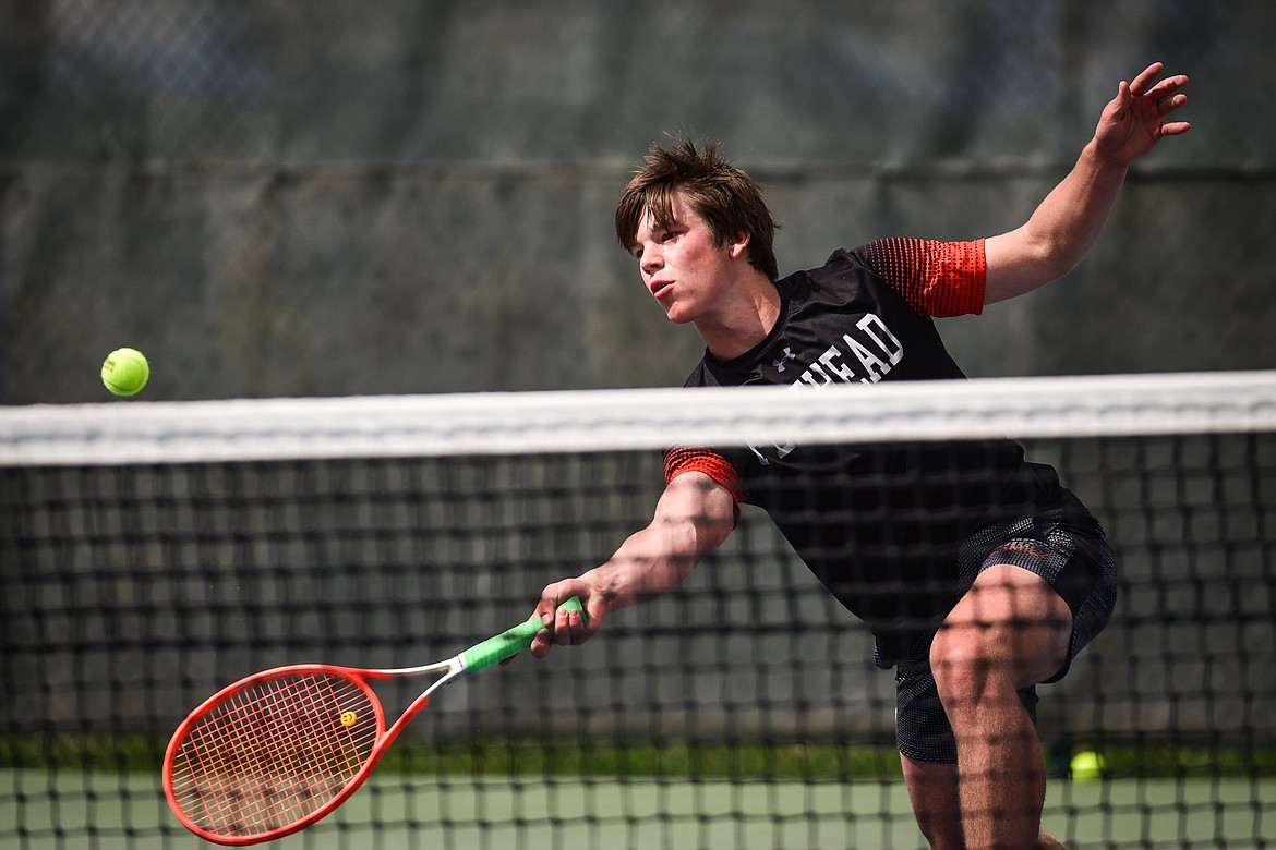 Flathead's Kutuk White hits a return against Glacier's Will Rudbach at Flathead Valley Community College on Thursday, May 12. (Casey Kreider/Daily Inter Lake)