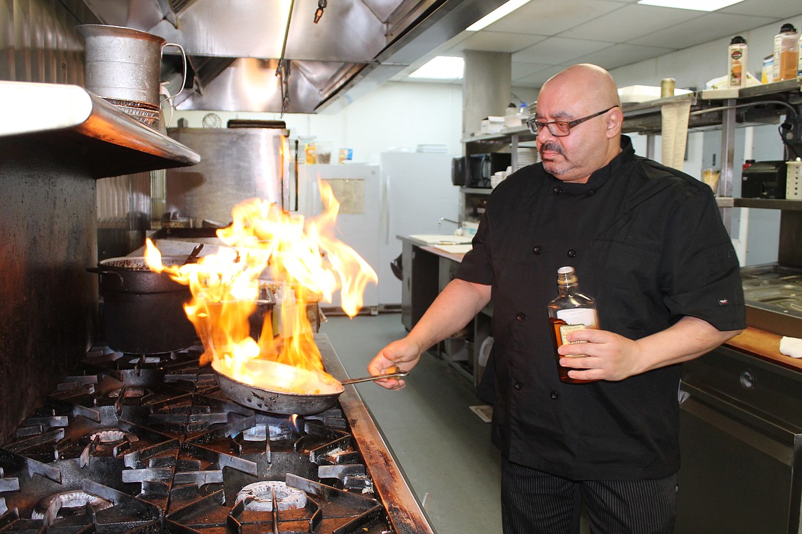 Pillar Rock Grill head chef Sameh Farag flambes vegetables for a dish. He said he tries to focus on fresh ingredients purchased as locally as possible. Farag isn't just about fancy shows though, the quality of his cooking has earned him multiple awards in local competitions.