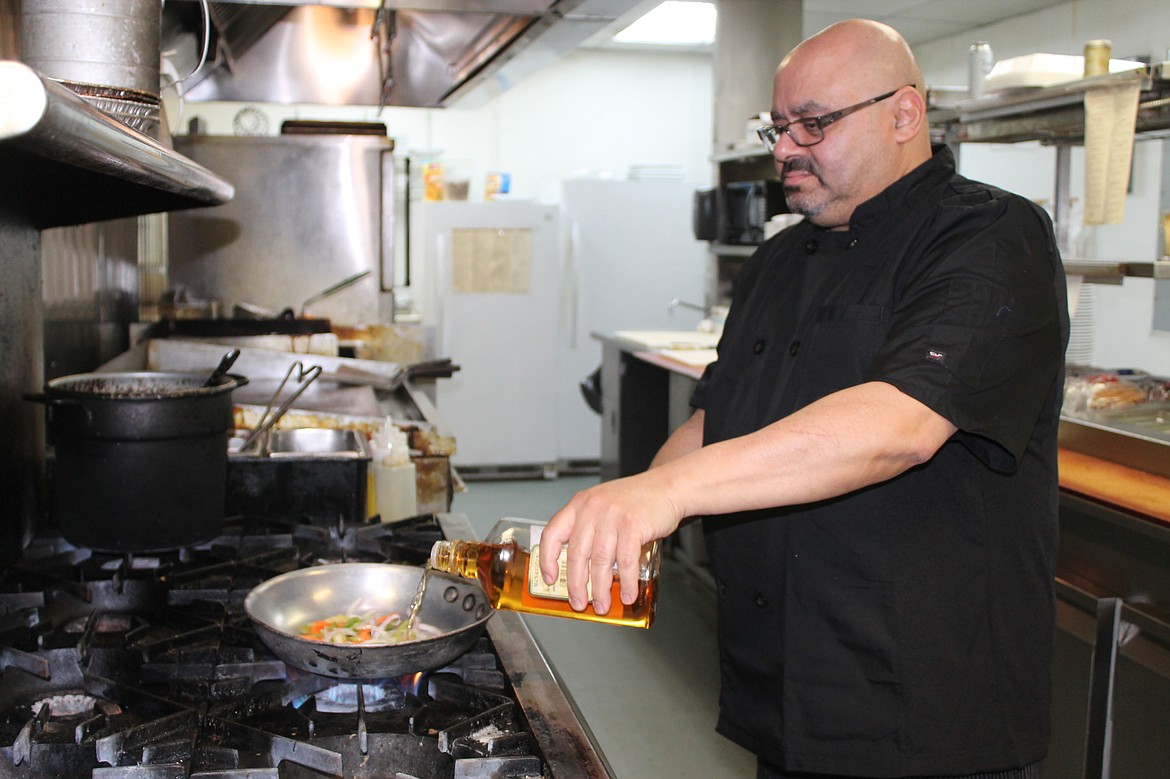 Sameh Farag, head chef at Pillar Rock Grill, works on a dish in the restaurant kitchen. Creativity is one of the attractions of cooking, he said. As head chef, he is also in charge of ensuring quality at the restaurant and keeping the kitchen organized.
