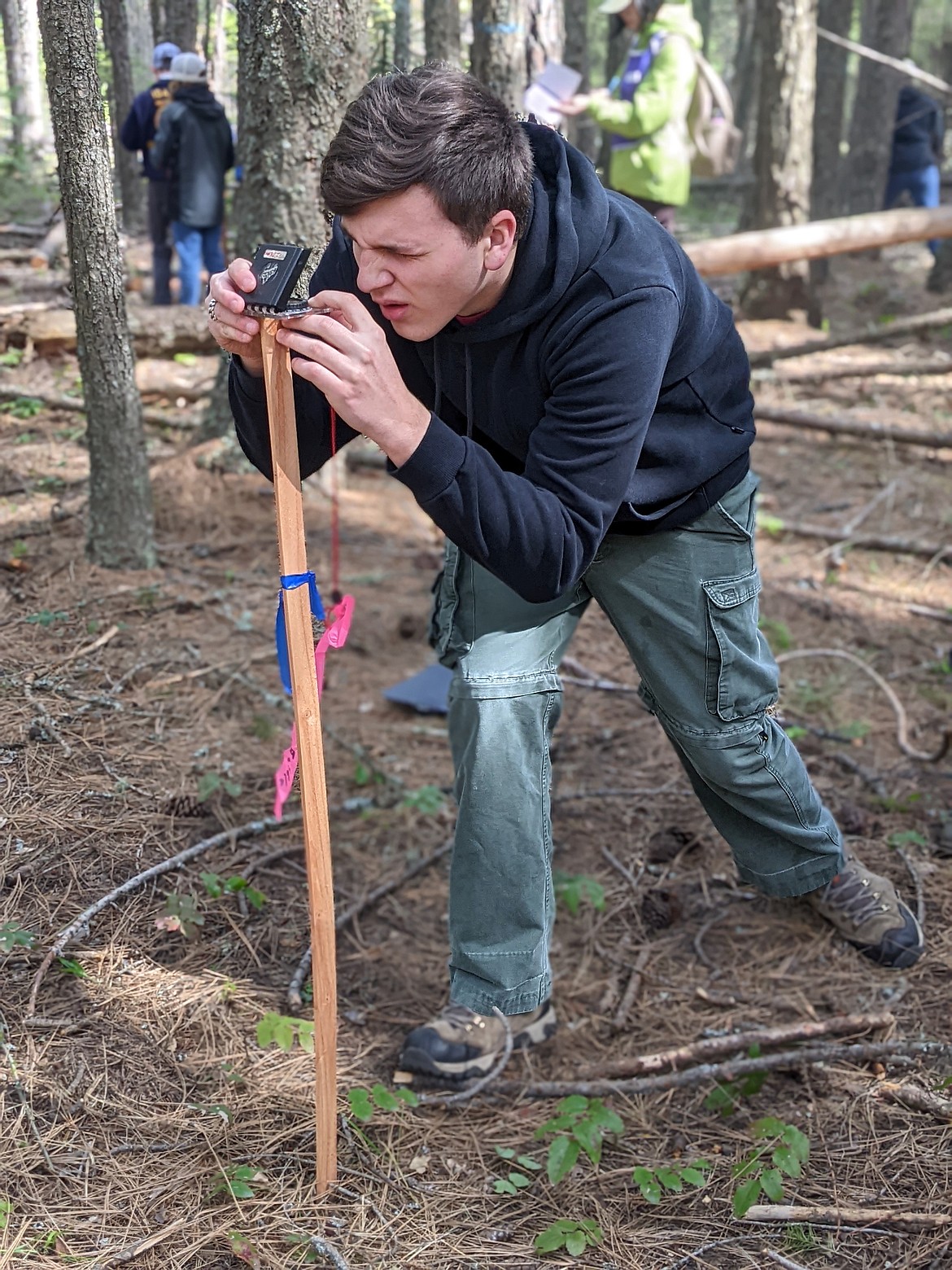 Jason Colegrove puts his compass to work during the Idaho State Forestry Contest Thursday at Farragut State Park. Dozens of students in grades five through 12 from throughout the state participated in the event, hosted annually by the Idaho Department of Lands.  CHANSE WATSON/Hagadone News Network