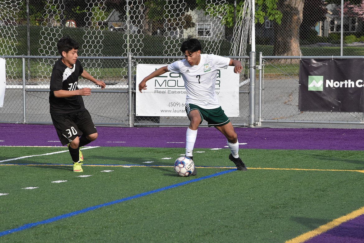 Quincy senior David Carillo (7) works the ball during the first half of the district matchup on Wednesday at Wenatchee.