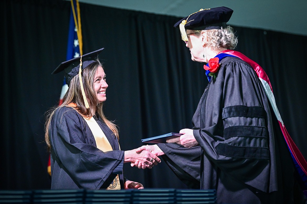 A graduate receives her diploma from Dr. Chris Clouse, vice president of Academic and Student Affairs, at Flathead Valley Community College's 54th commencement ceremony on Friday, May 13. A total of 304 graduates earned 319 degrees and certificates. (Casey Kreider/Daily Inter Lake)