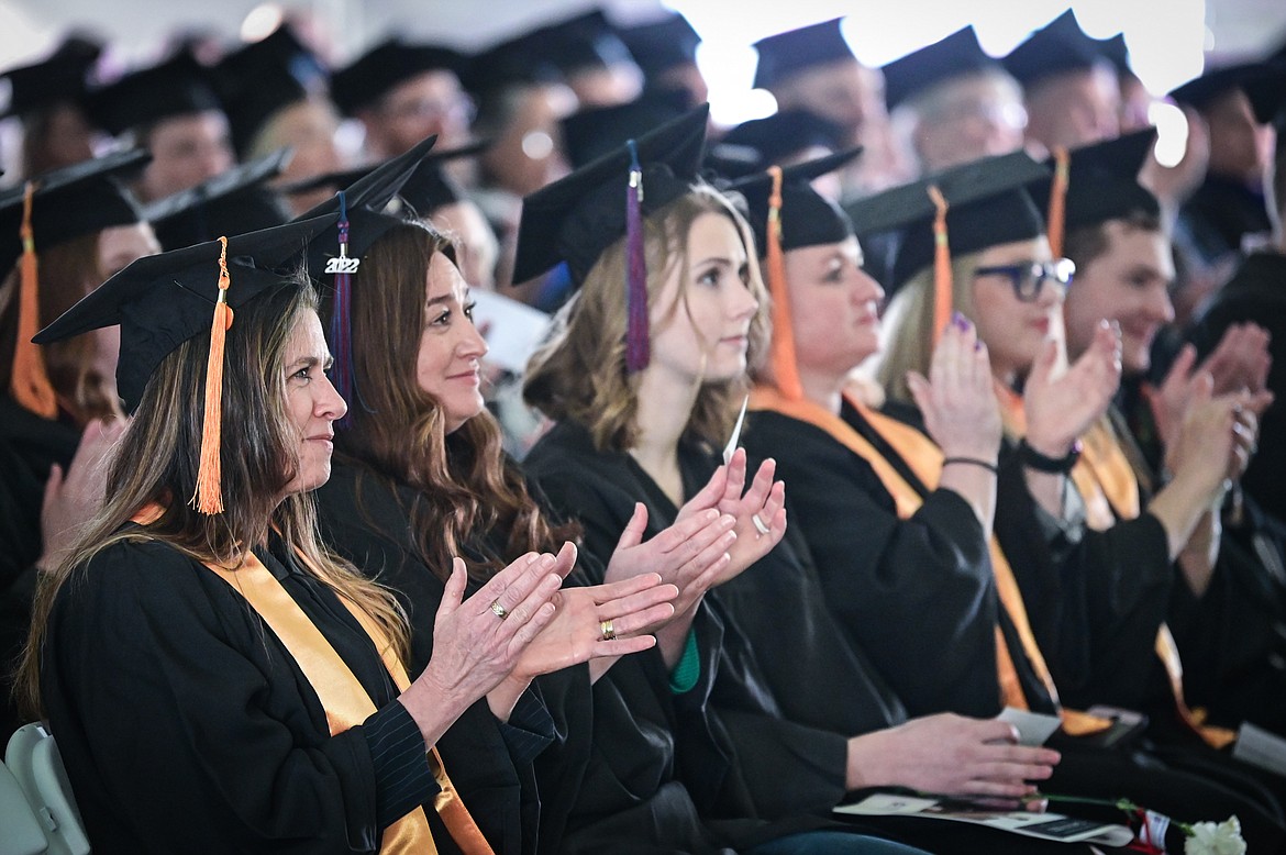 Graduates clap after a speech by Connie Hitchcock, faculty of the Business and Technologies Division, at Flathead Valley Community College's 54th commencement ceremony on Friday, May 13. A total of 304 graduates earned 319 degrees and certificates. (Casey Kreider/Daily Inter Lake)