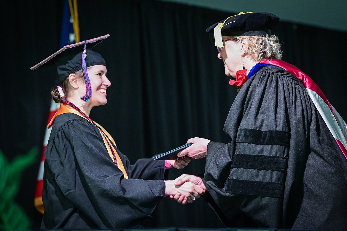 A graduate receives her diploma from Dr. Chris Clouse, vice president of Academic and Student Affairs, at Flathead Valley Community College's 54th commencement ceremony on Friday, May 13. A total of 304 graduates earned 319 degrees and certificates. (Casey Kreider/Daily Inter Lake)