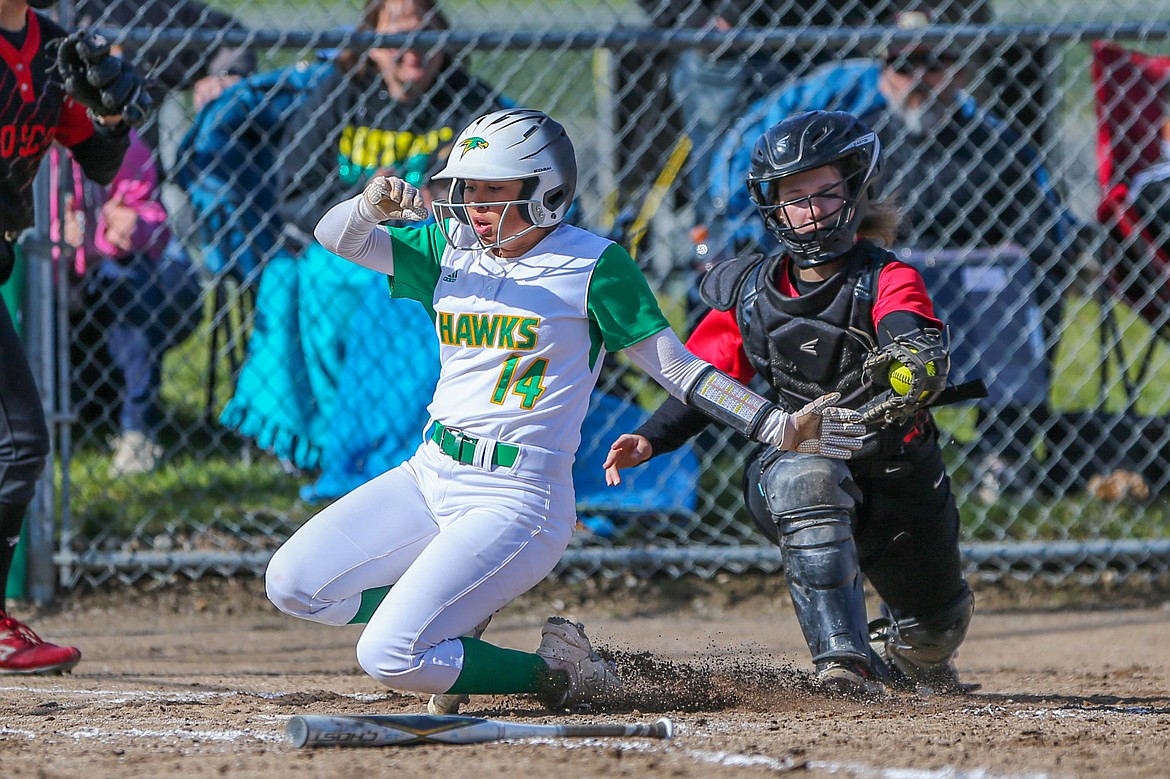 JASON DUCHOW PHOTOGRAPHY
Emma Avalos (14) of Lakeland slides in safely while scoring on a sacrifice fly in the sixth inning, and Moscow catcher Megan Highfill tries to apply the tag in Game 2 of the 4A Region 1 softball best-of-3 championship series Friday at Lakeland High.