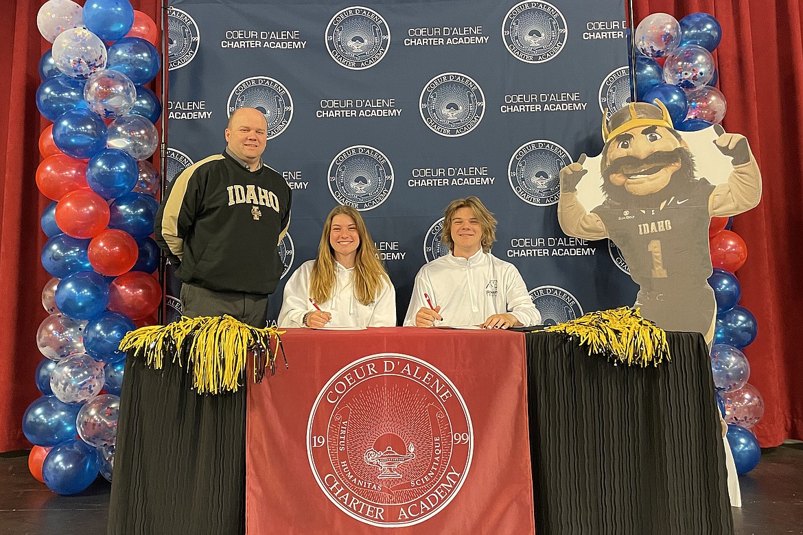 Coeur d'Alene Charter Academy seniors Danika and Nikolas Nowak signed letters of intent to attend the University of Idaho in Moscow. Pictured are Danika and Nikolas with Charter Vice Principal Aaron Lippy.