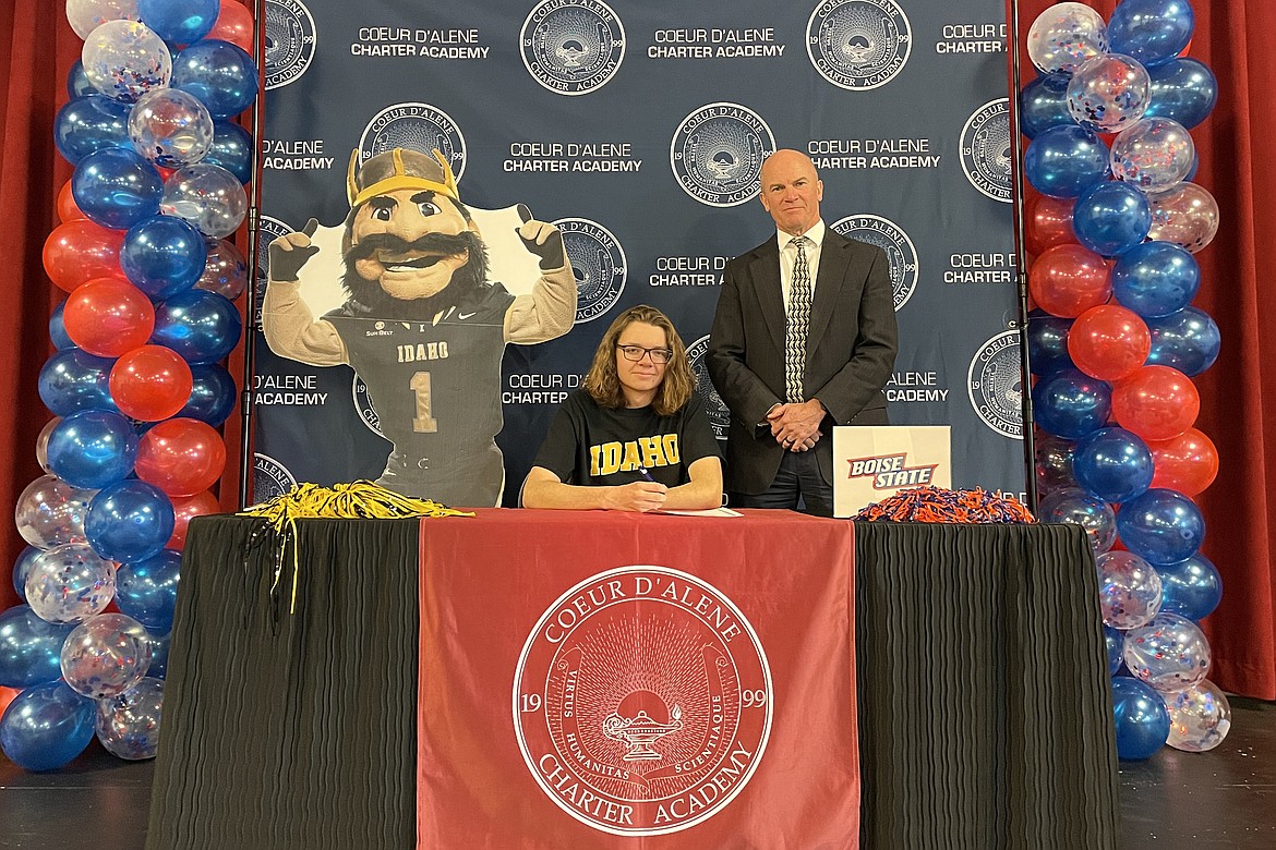 Coeur d'Alene Charter Academy senior Jacob McGaughey signed a letter of intent to attend either the University of Idaho in Moscow or Boise State University in Boise. Pictured with Jacob is Charter Principal Dan Nicklay.