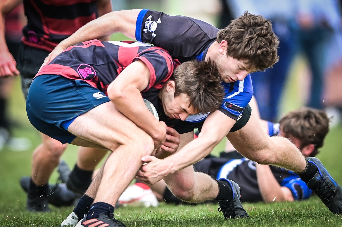 Flathead Valley Black and Blue's Fin Nadeau (9) tackles a Missoula Mud Dog opponent during the championship game at the State Rugby Tournament at Glacier High School on Saturday, May 14. (Casey Kreider/Daily Inter Lake)