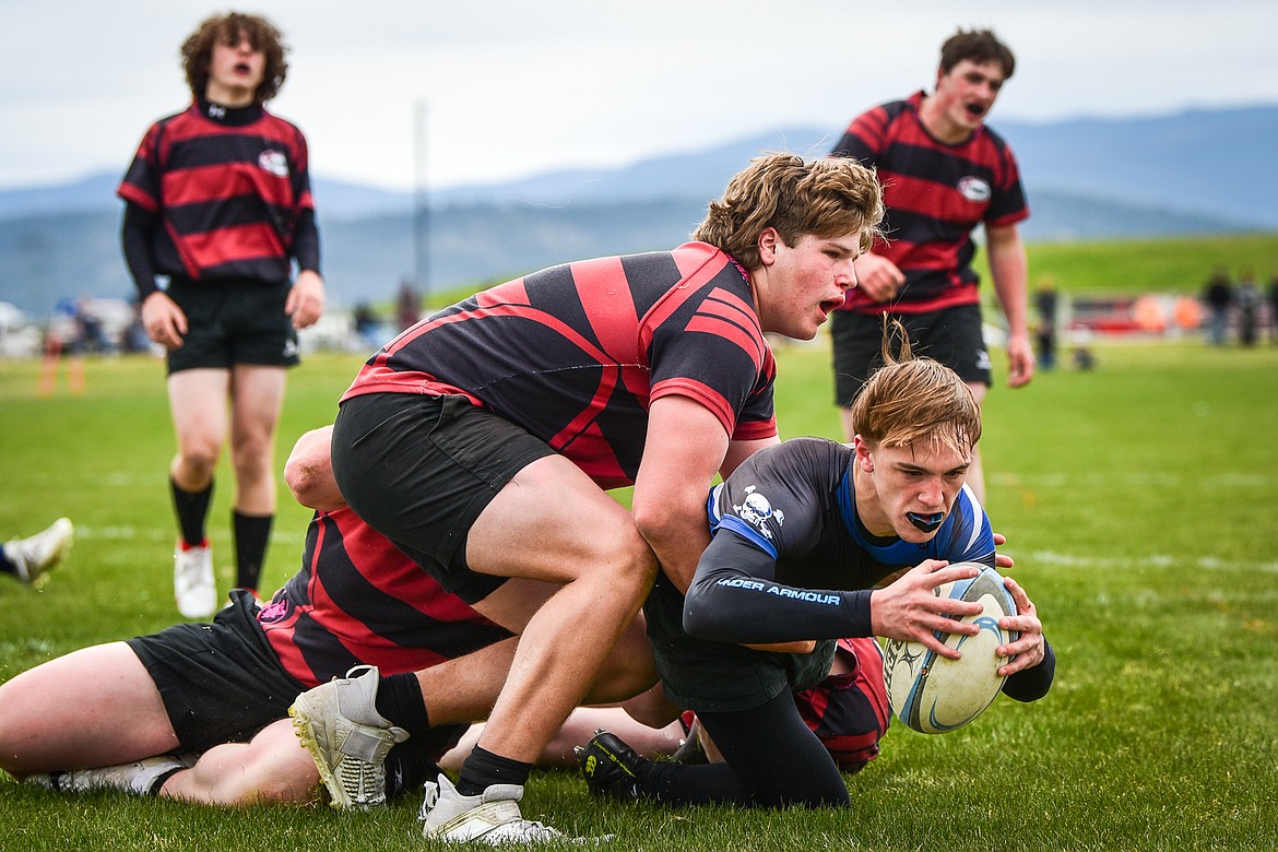 Flathead Valley Black and Blue's Sawyer Troupe (13)  is stopped just short of a try against the Missoula Mud Dogs during the championship game of the State Rugby Tournament at Glacier High School on Saturday, May 14. (Casey Kreider/Daily Inter Lake)