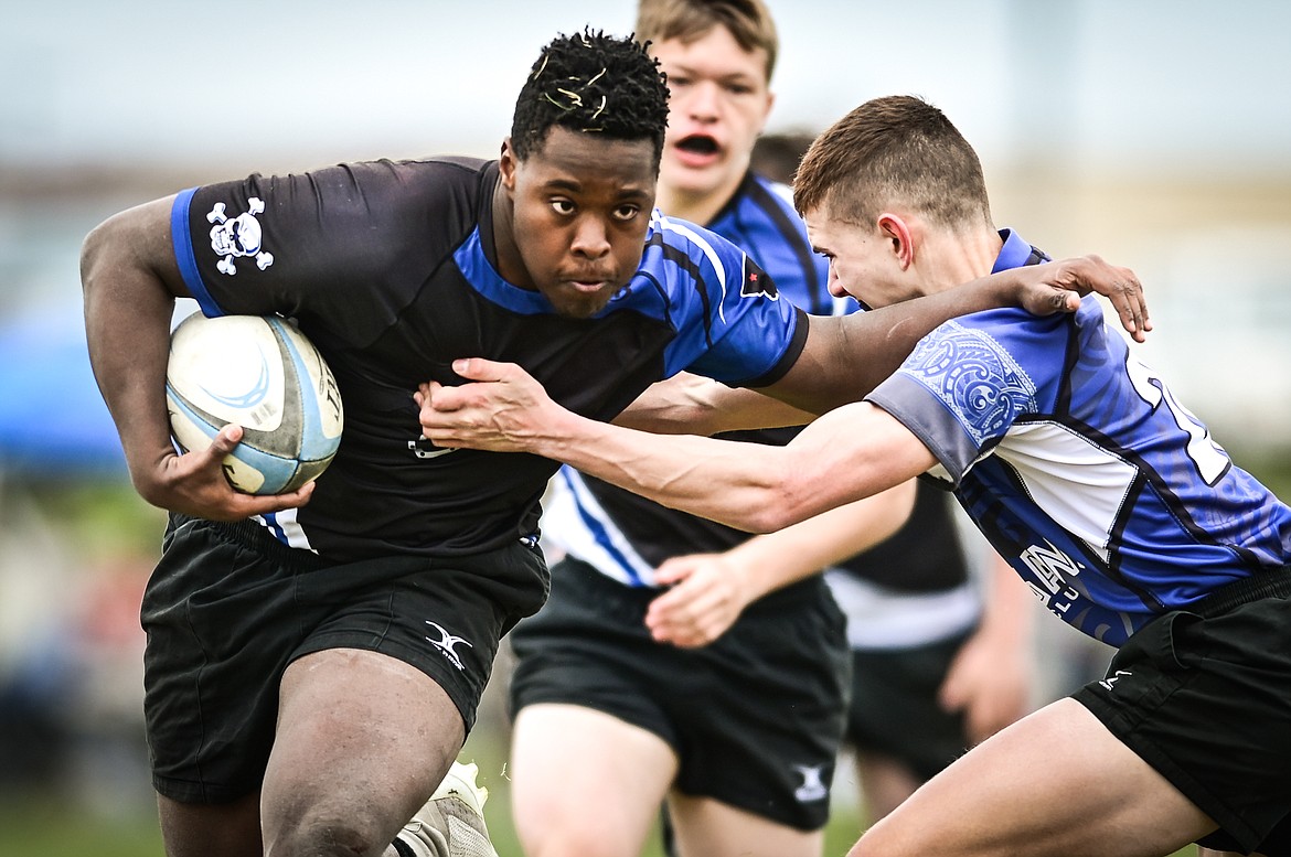 Flathead Valley Black and Blue's Matthew Melby (21) runs with the ball against the Helena Hooligans in the semifinals of the State Rugby Tournament at Glacier High School on Saturday, May 14. (Casey Kreider/Daily Inter Lake)