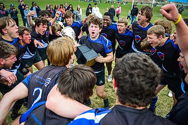 Flathead Valley Black and Blue captain Fin Nadeau holds the championship trophy as the team celebrates after a 12-0 win over the Missoula Mud Dogs at the State Rugby Tournament at Glacier High School on Saturday, May 14. (Casey Kreider/Daily Inter Lake)