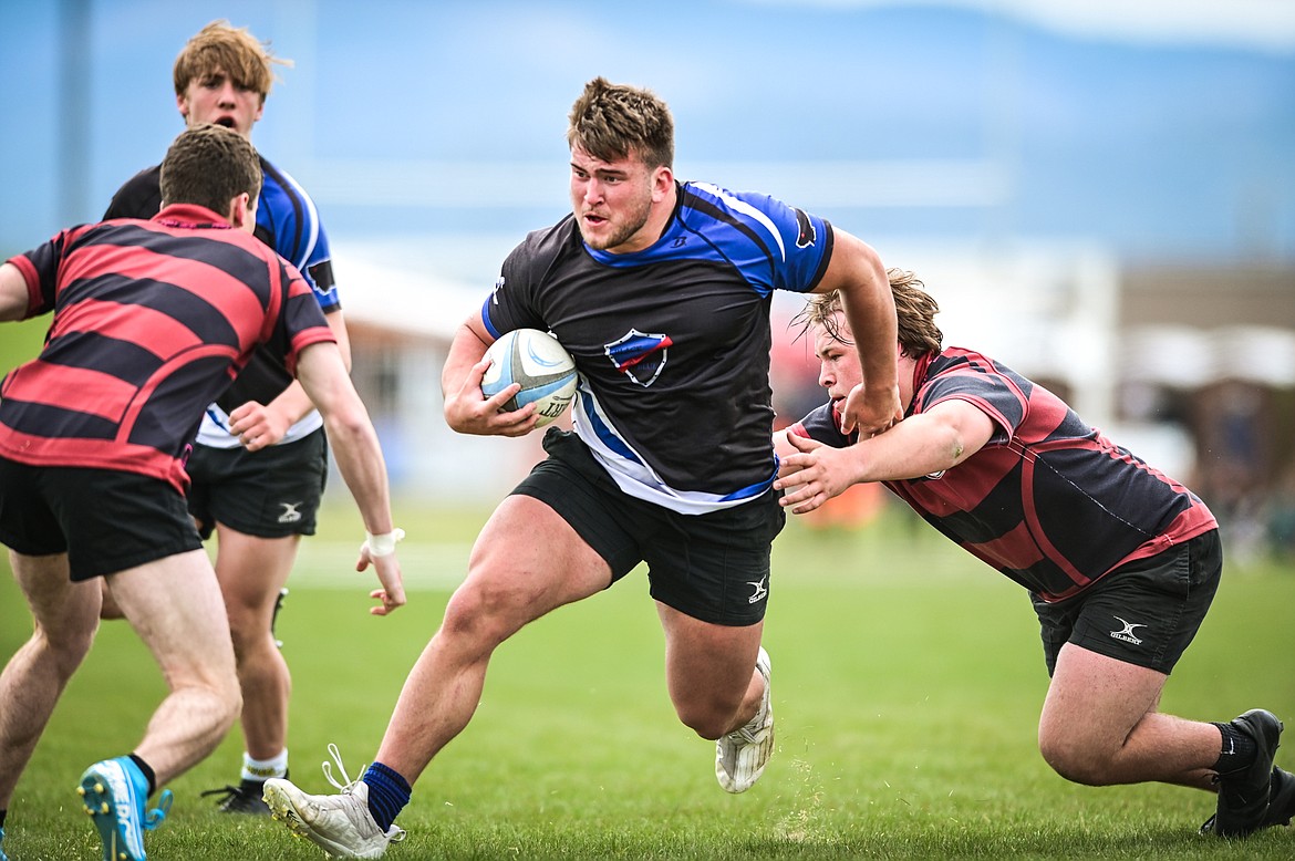 Flathead Valley Black and Blue's Jake Rendina (1) runs with the ball against the Missoula Mud Dogs during the championship game of the State Rugby Tournament at Glacier High School on Saturday, May 14. (Casey Kreider/Daily Inter Lake)