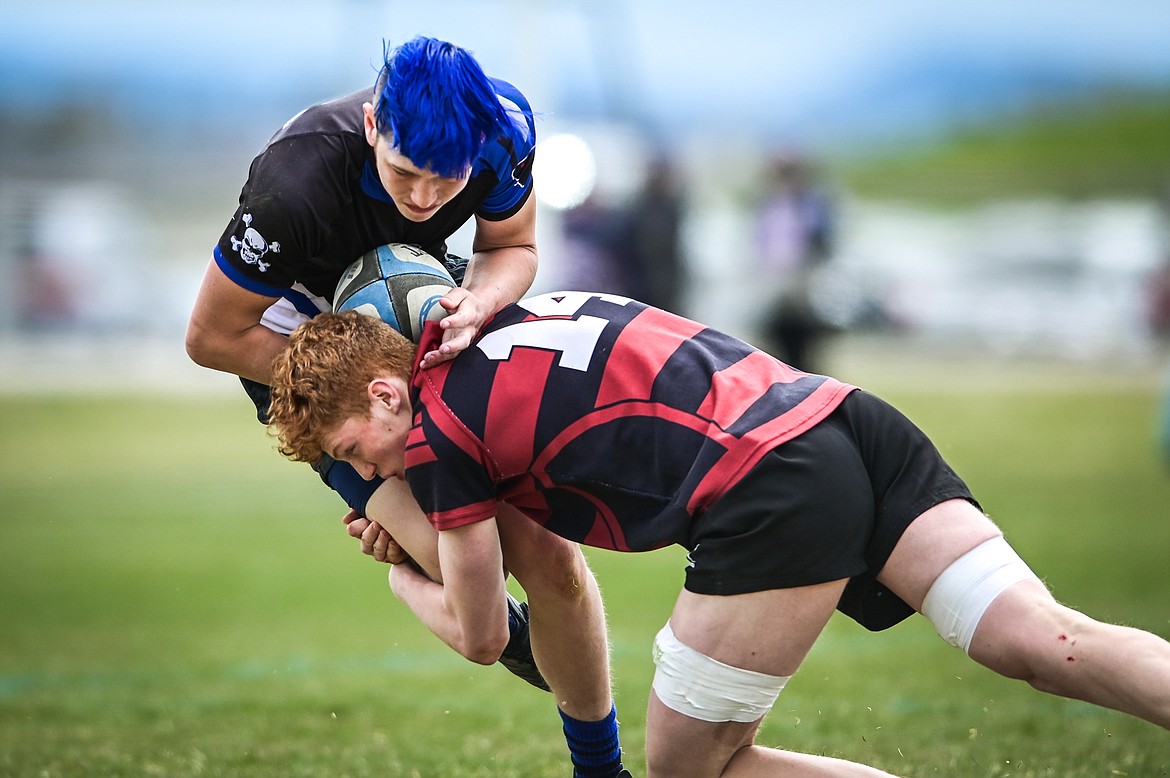 Flathead Valley Black and Blue's Toby Snackenberg (16) is tackled by a Missoula Mud Dog opponent after a run during the championship game of the State Rugby Tournament at Glacier High School on Saturday, May 14. (Casey Kreider/Daily Inter Lake)