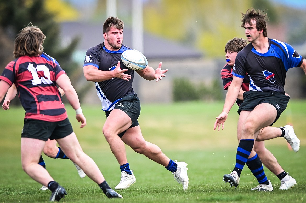 Flathead Valley Black and Blue's Jake Rendina (1) receives a pass from Luke Leech (4) in the championship game against the Missoula Mud Dogs in the State Rugby Tournament at Glacier High School on Saturday, May 14. (Casey Kreider/Daily Inter Lake)