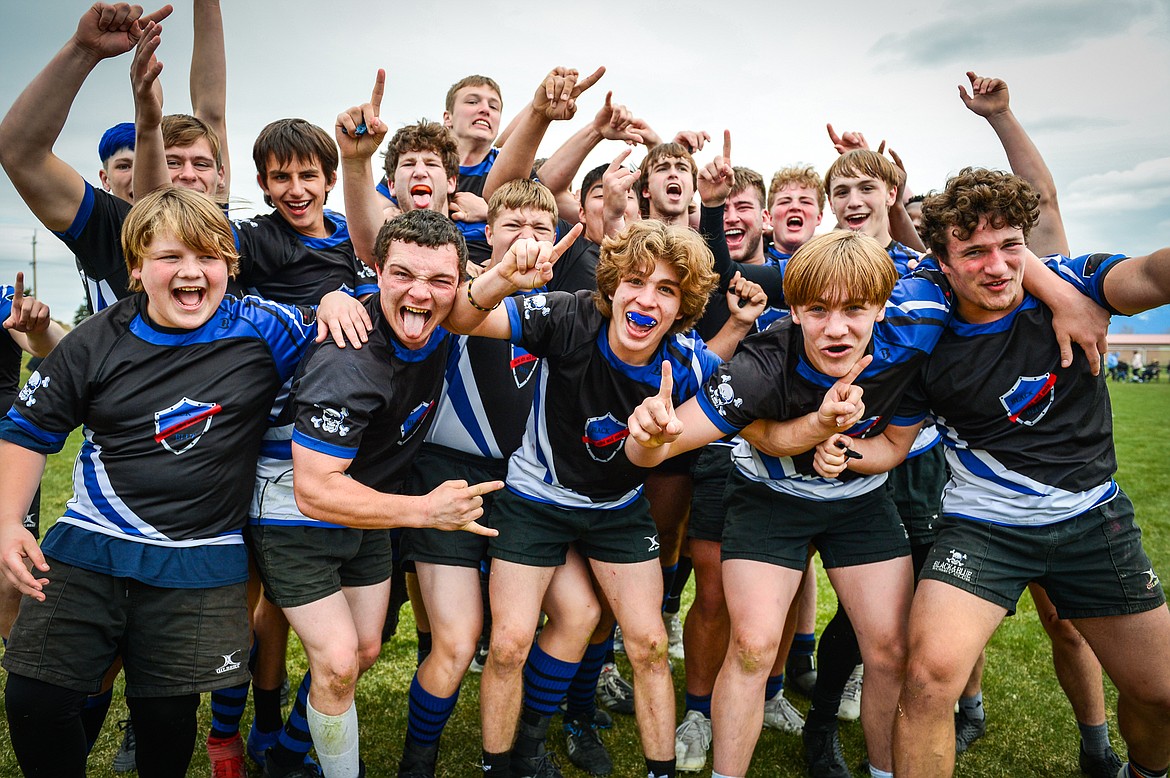The Flathead Valley Black and Blue celebrate on the field after their 12-0 win over the Missoula Mud Dogs in the championship game of the State Rugby Tournament at Glacier High School on Saturday, May 14. (Casey Kreider/Daily Inter Lake)