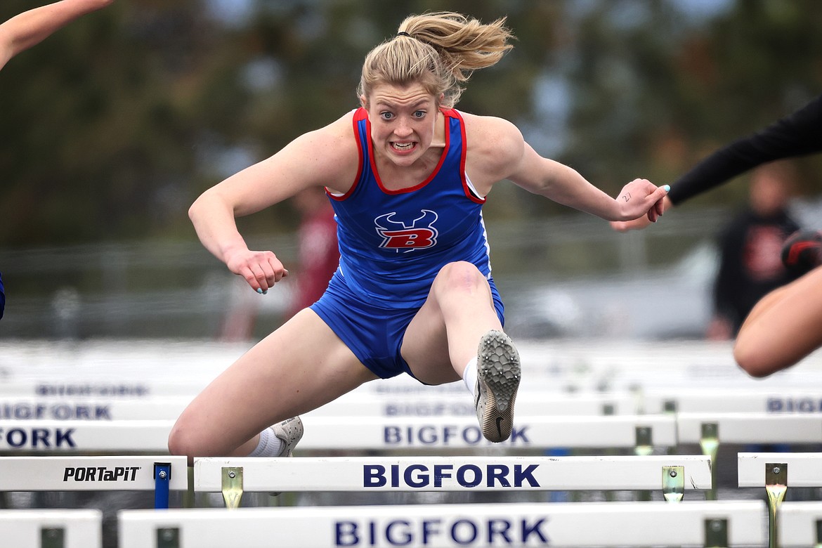 Bigfork's Lily Tanko runs the 100 hurdles at the District 7-B track meet at Bigfork High School on Saturday, May 14. (Jeremy Weber/Daily Inter Lake)