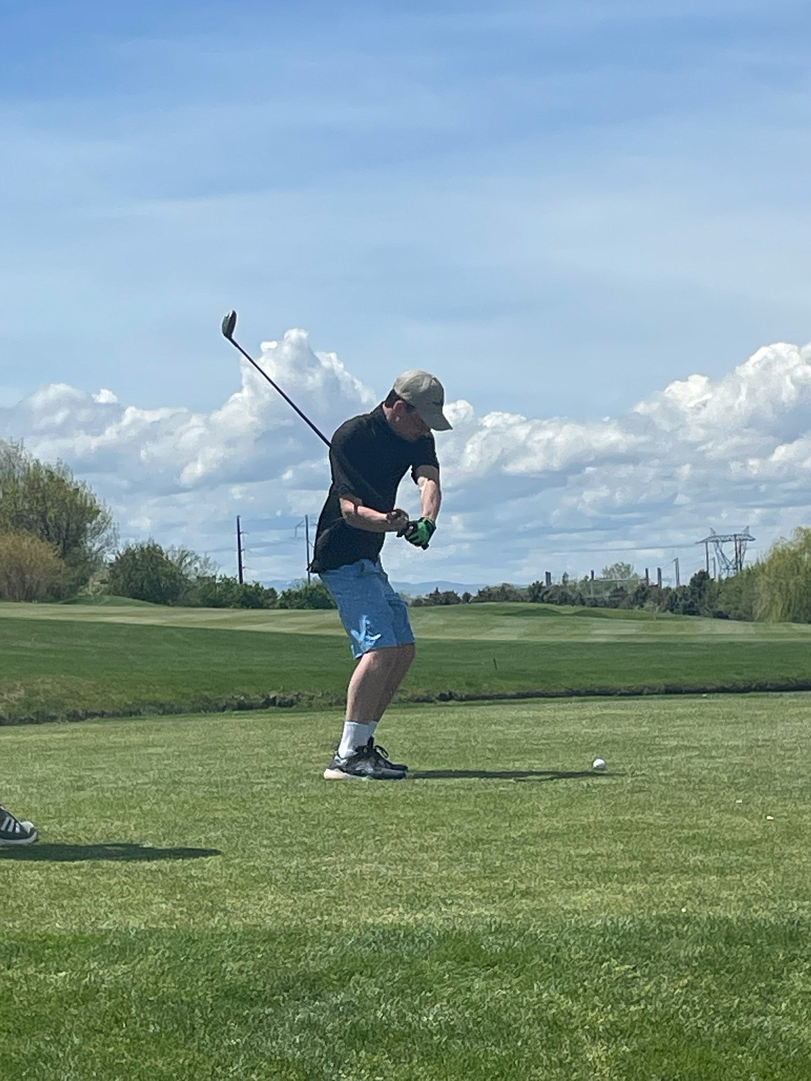 Cole Reuter lining up a shot at the Falcon Crest Golf Club at the Idaho Class 2A state golf tournament.