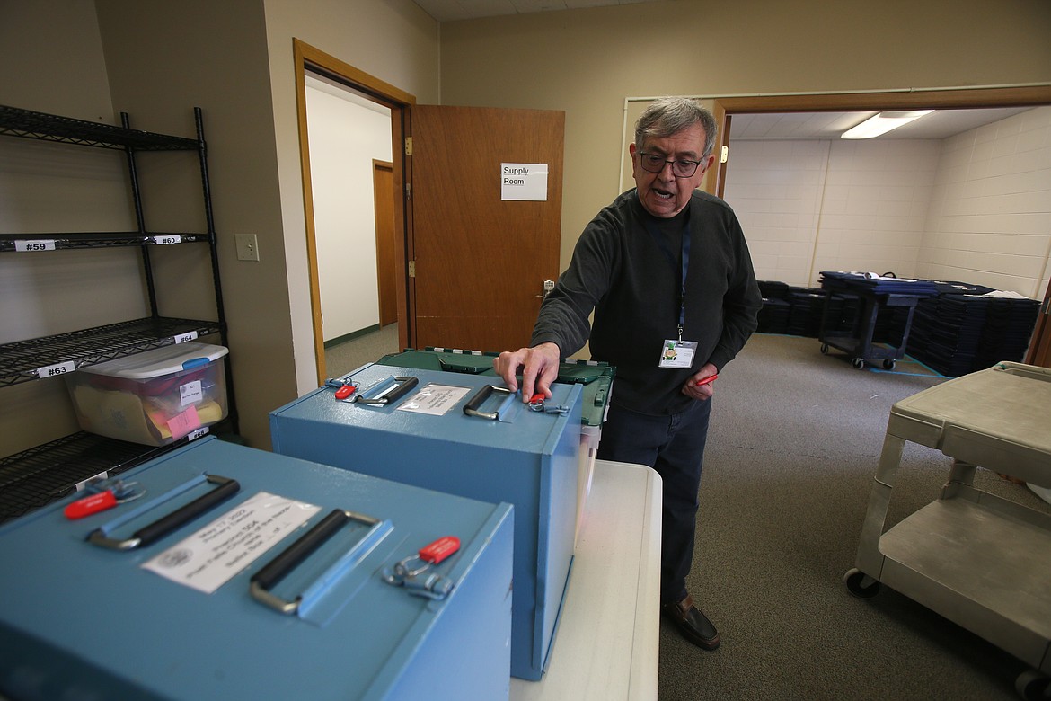 Kootenai County clerk Jim Brannon on Monday points out locking mechanisms as he discusses security measures taken with each ballot box. Voting for today's primary election goes from 8 a.m. to 8 p.m.