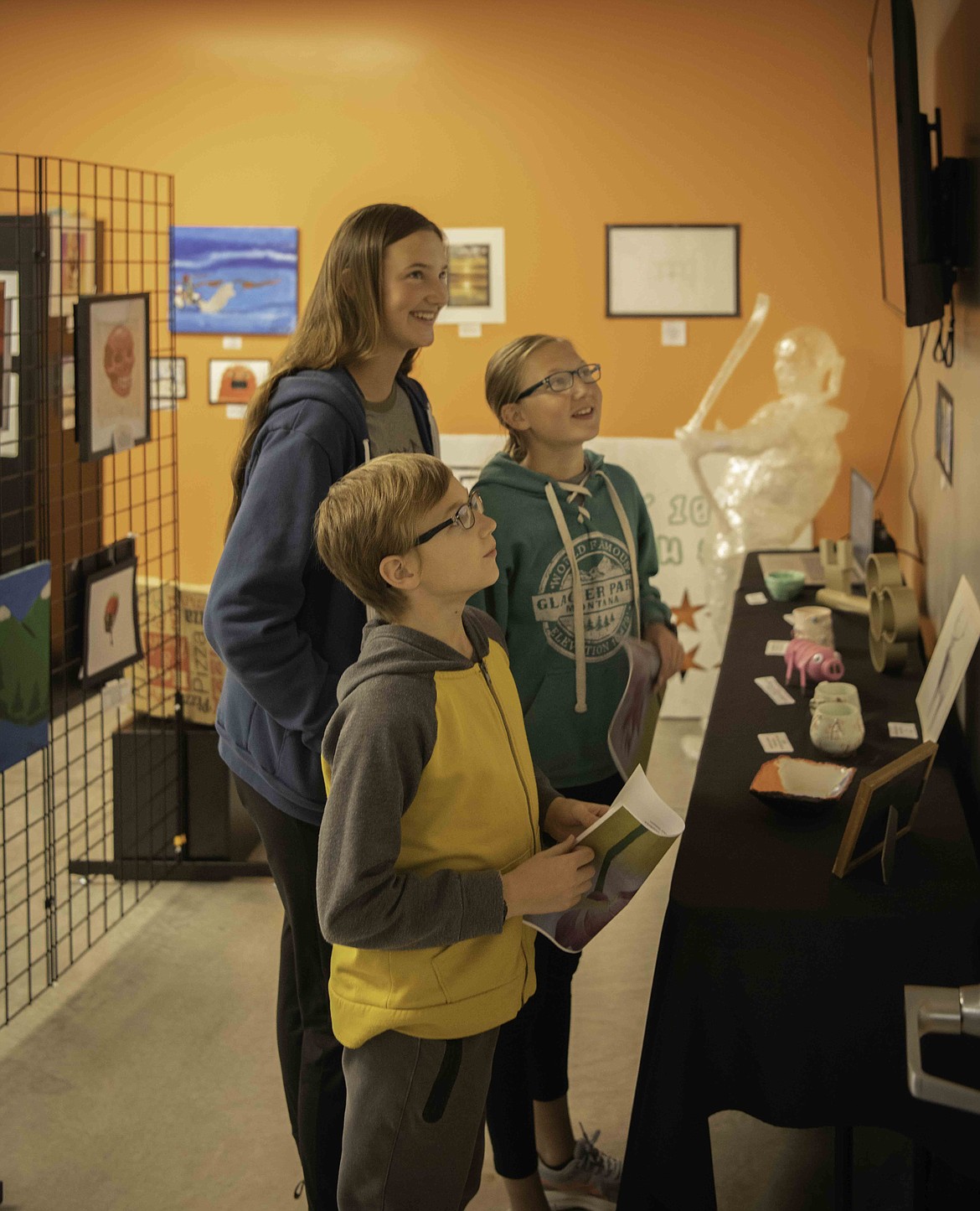Emory Ercanbrack and Kalem Ercanbrack admire displays at the art show.