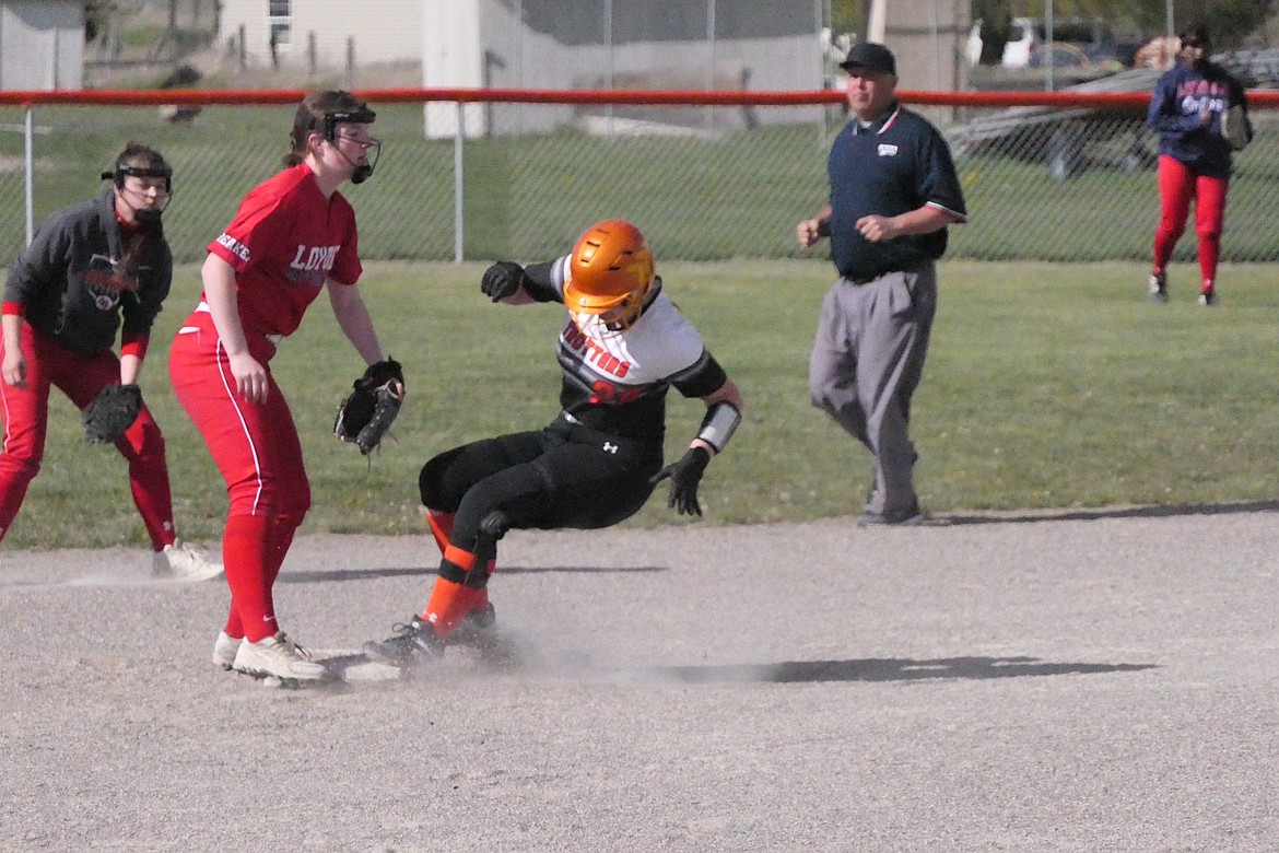 Plains' Maddy Blood slides (kind of) into second base after moving over on a wild pitch in the Trotters game with Missoula Loyola last week.  (Chuck Bandel/VP-MI)