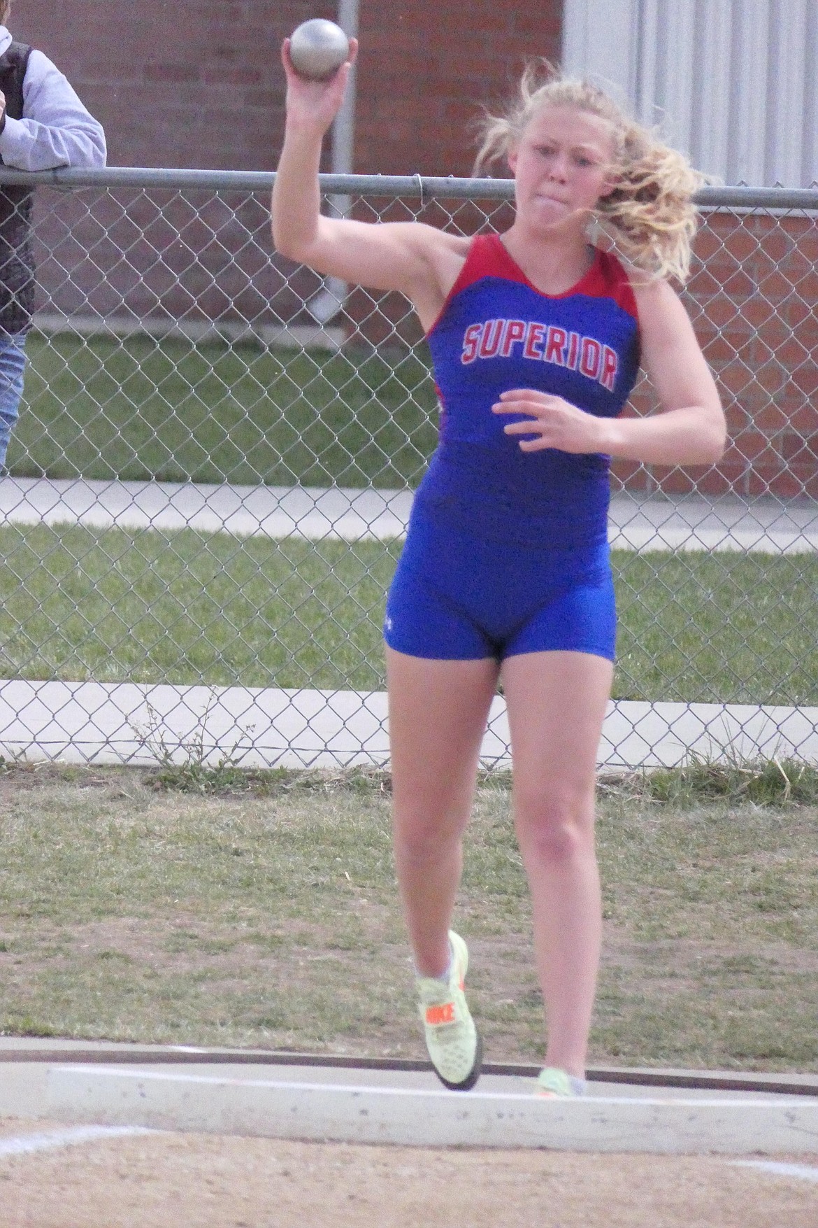 Girls shot put winner Cassie Green of Superior lets the iron ball fly as she takes home first in the event, just ahead of Hot Springs'  Katelyn Christensen.  (Chuck Bandel/MI-VP)