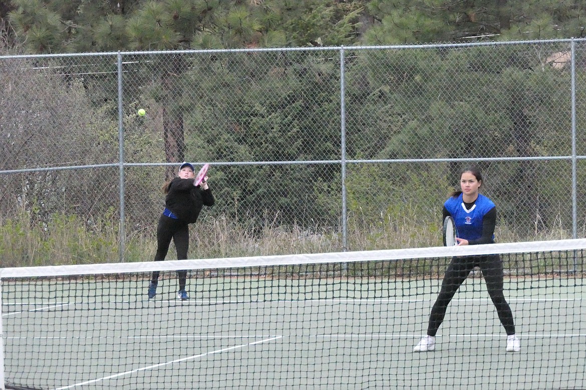 Brook Bibler returns shot as doubles partner Molia Dao readies for a return from their Mission opponents during Saturday's Divisional tennis matches in Bigfork.  Bibler and Dao finished second and advanced to the State finals this weekend in Bozeman.  (Chuck Bandel/VP-MI)