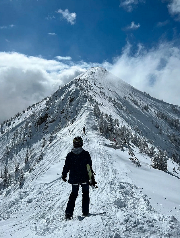 A snowboarder at Bridger Bowl looks toward Saddle Peak recently. (Credit: Jackson Rohleder / MTFP)