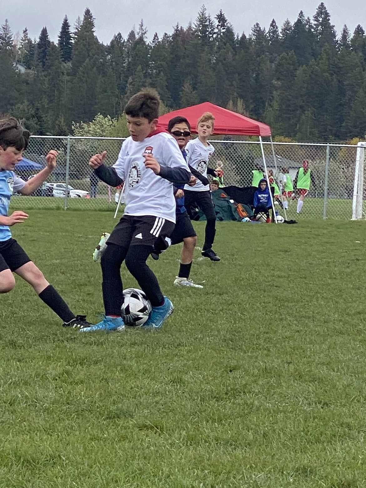 Photo by KRISTIN BRENNAN
The Timbers 2013 Boys Yellow soccer team beat the Spokane Sounders B2013 North Carson team on Saturday 7-2. Timbers goals were scored by Maddex Arana (2), Sullivan O'Dowd (1), Carter Mitchell (1), Crew Kuhlmann (1) and Maverick Sargent (2), with an assist by Brody Brennan. Pictured is Aiden Mojzis of the Timbers, using his footwork against a Sounders defender.