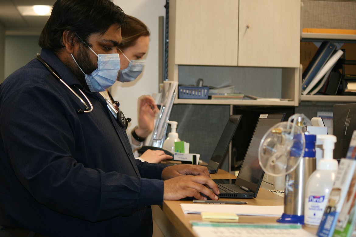 Family medicine physicians Pranav Patel (foreground) and Lisa Kieneker (background) work at the nurse’s station in the Samaritan Clinic on Patton Boulevard Monday. The clinic has recently expanded.