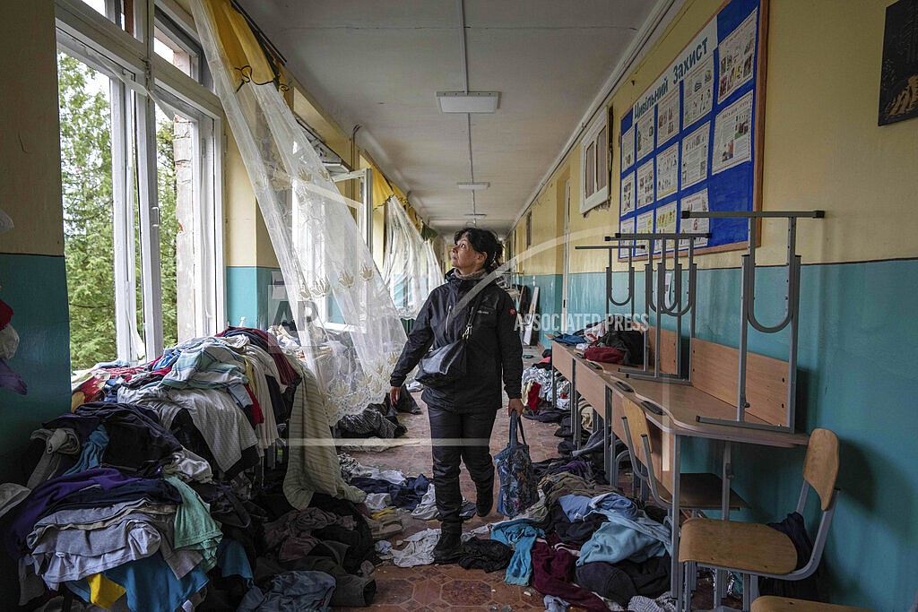 School official Iryna Homenko walks in the hall of a school damaged by an airstrike from Russian forces in Chernihiv, Ukraine, Wednesday, April 13, 2022. In Chernihiv alone, the city council said only seven of the city’s 35 schools were unscathed. Three were reduced to rubble. (AP Photo/Evgeniy Maloletka, File)