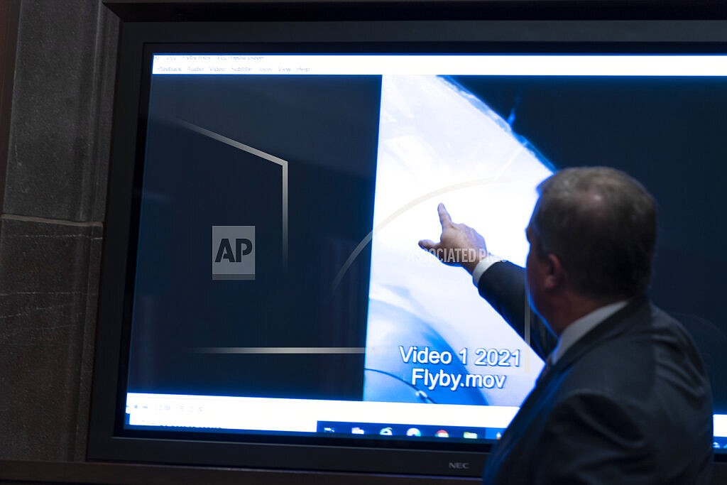 Deputy Director of Naval Intelligence Scott Bray points to a video display of a UAP during a hearing of the House Intelligence, Counterterrorism, Counterintelligence, and Counterproliferation Subcommittee hearing on "Unidentified Aerial Phenomena," on Capitol Hill, Tuesday, May 17, 2022, in Washington. (AP Photo/Alex Brandon)