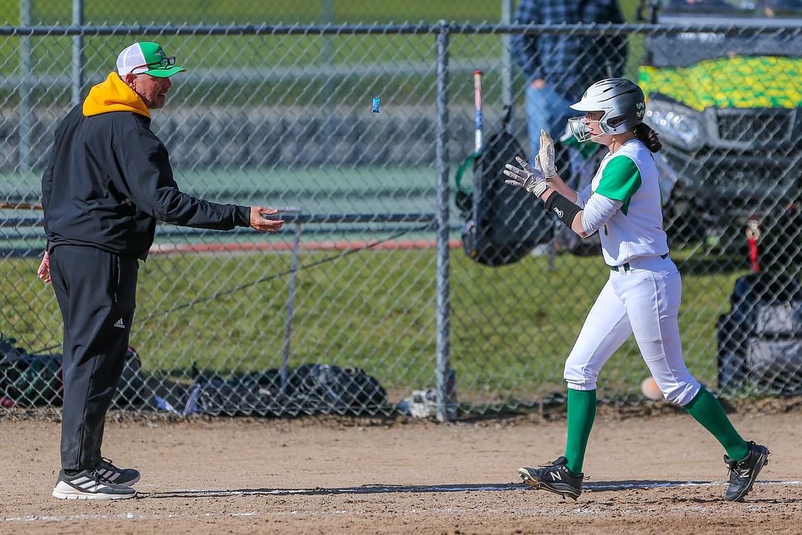 JASON DUCHOW PHOTOGRAPHY
Lakeland High softball coach Dwayne Curry tosses a piece of candy to Cienna Walls after the Hawks' senior homered in last Friday's 4A Region 1 softball championship game in Rathdrum.