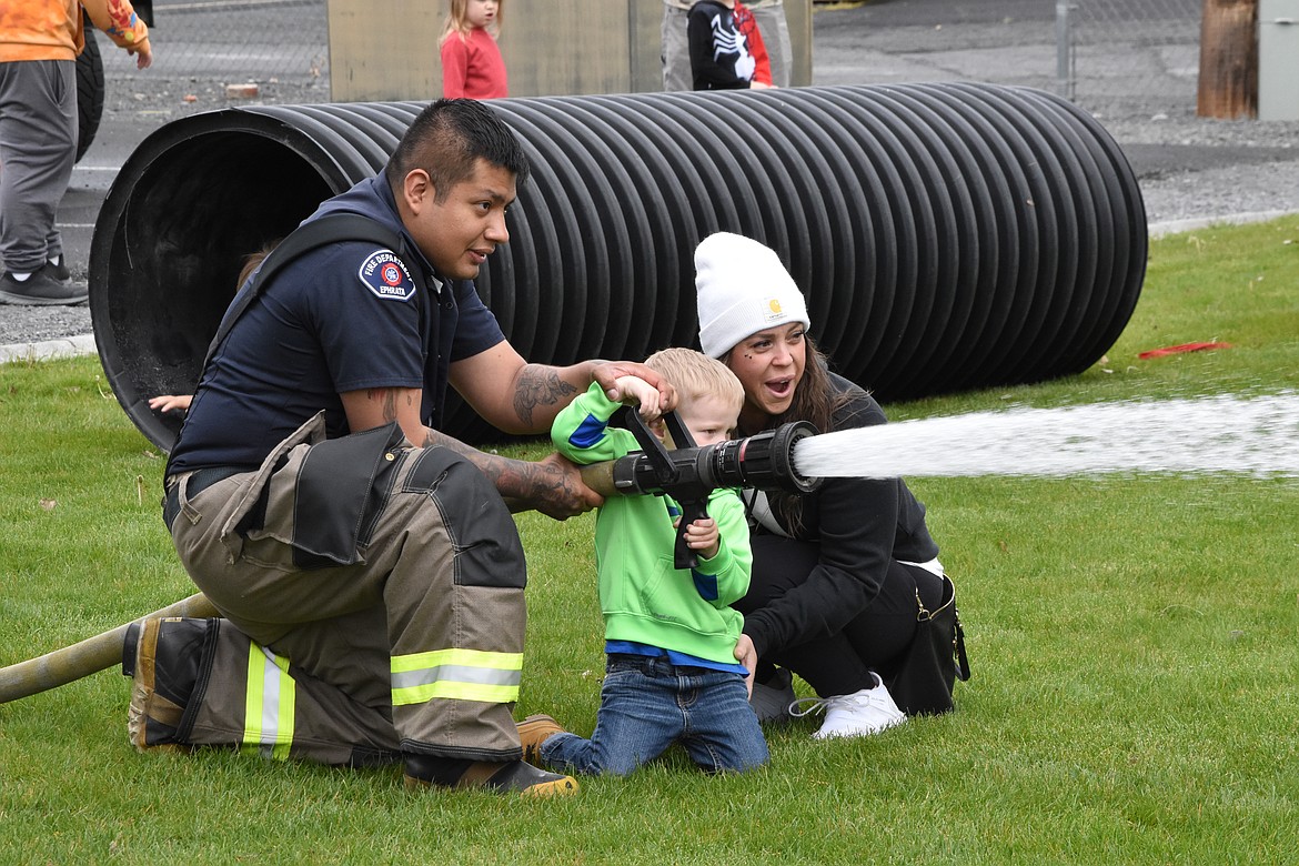 The Ephrata Fire Department had a firehose set up and a firefighter helped children to spray the hose to ‘put out’ a fire. First responder organizations take opportunities such as Touch-A-Truck to connect with local children and educate them on safety.