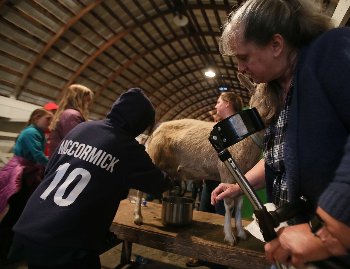 Tina Bothwell supervises as Ramsey Magnet School of Science fifth-grader Margarita McCormick milks a goat at the Kootenai County Fairgrounds on Wednesday.