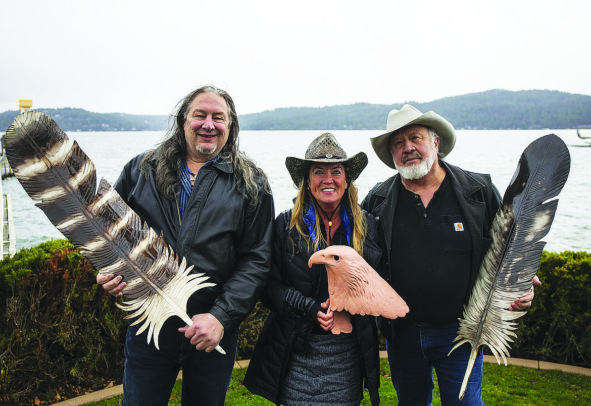 Artists David Govedare, left, and Keith Powell pose with models of their public artwork, “The Guardians of the Lake,” which has decorated Northwest Boulevard for 20 years. Jamie Veltcamp of the Birds of Prey Northwest is with them in this April 2018 Press photo.