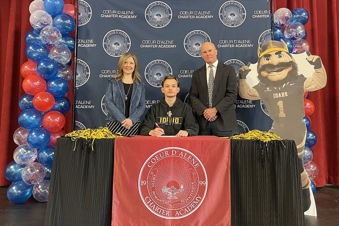 Coeur d'Alene Charter Academy senior Noah Aparicio signed a letter of intent to attend the University of Idaho in Moscow. Pictured are Charter teacher Sandy Midgley, Noah and Principal Dan Nicklay.