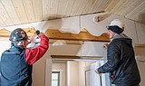 Building trades putting final touches on cabin, shed