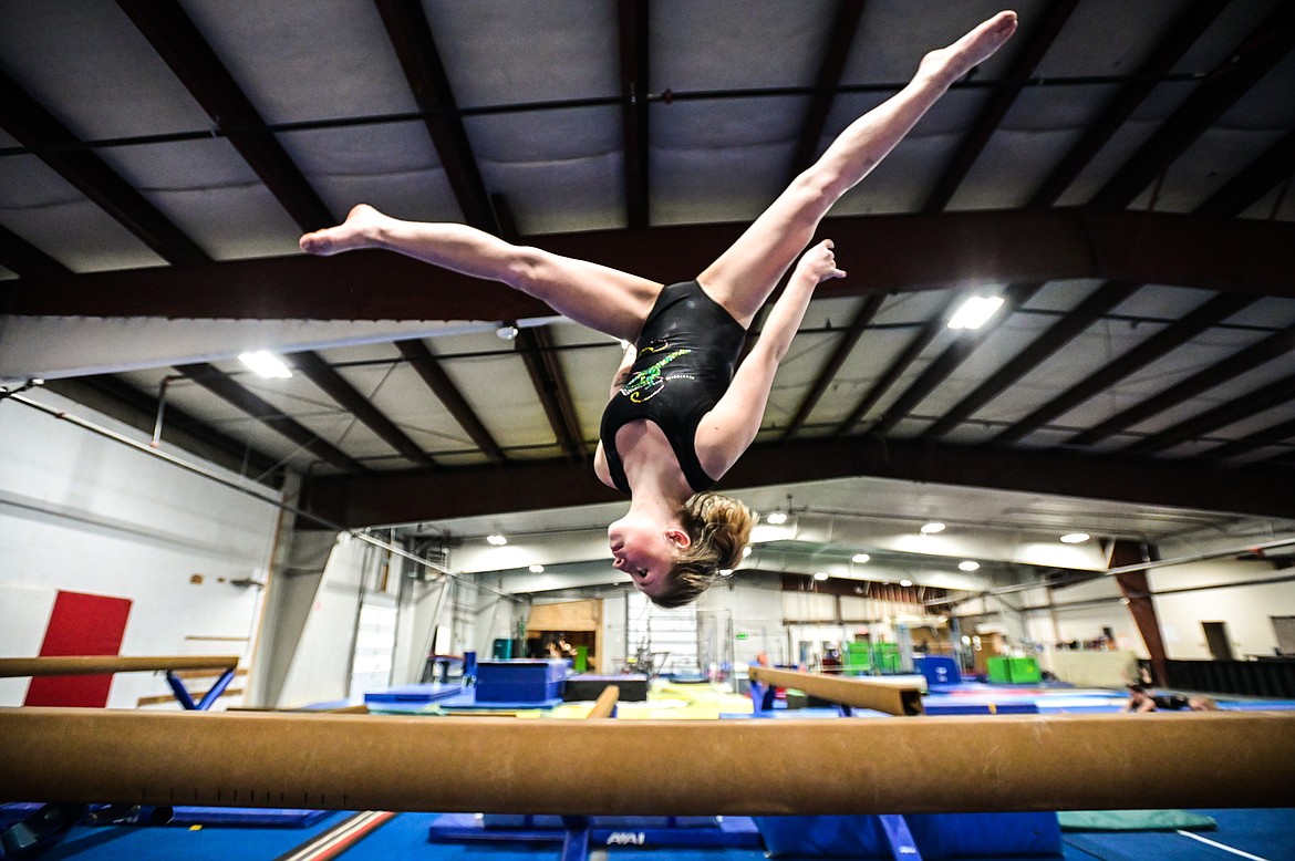 Gymnast Lucy Toelcke practices an aerial on the balance beam at Flathead Gymnastics Academy in Kalispell on Thursday, May 19. (Casey Kreider/Daily Inter Lake)