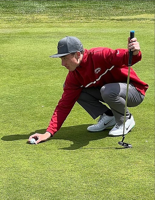 Senior Caiden Gubler lines up a shot on the course. Gubler is the first Chiefs golfer to make state since 2018.