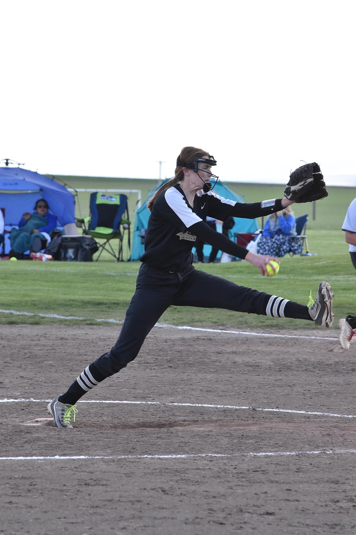 Cutline Royal pitcher Kate Larsen winds up for a pitch in the Lady Knight’s May 10 game against Warden.