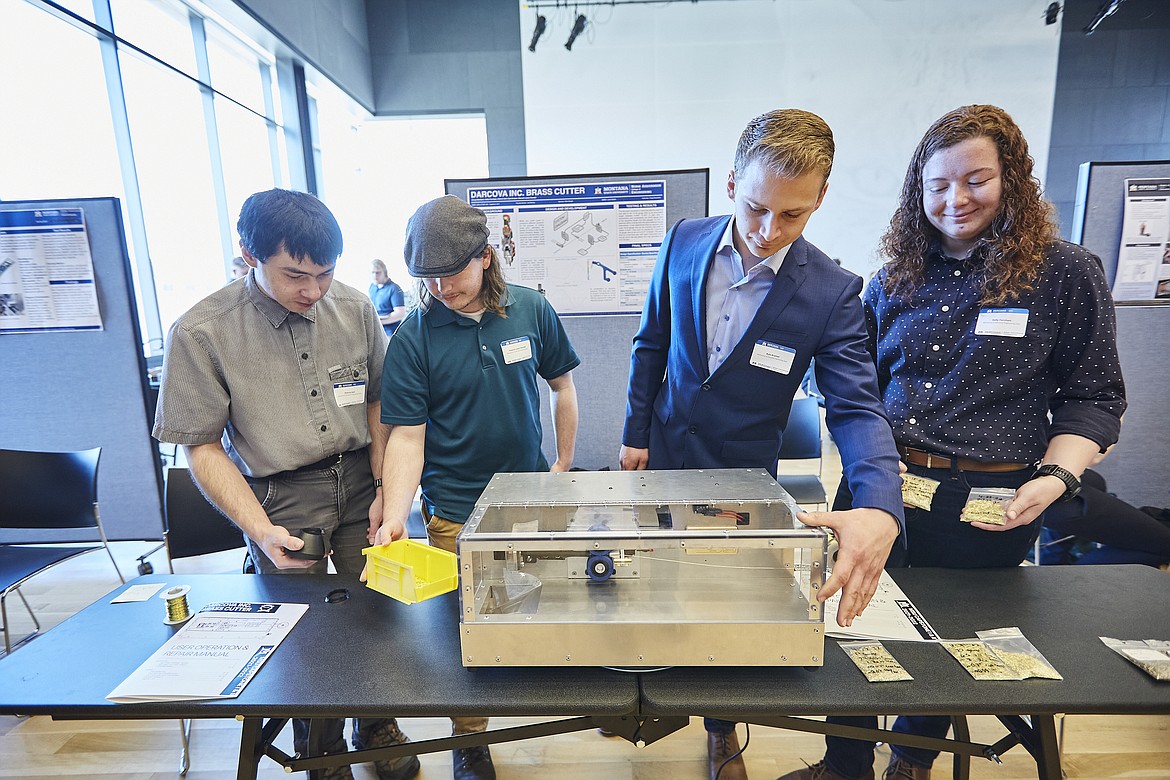 MSU engineering students, from left, Patrick Galt, Dawson Lewis Randall, Kyle Kramer and Kelly Farnham, showcase their capstone project, a manufacturing device for Billings-based company Darcova, during the biannual Design Fair on May 5. (MSU Photo by Adrian Sanchez-Gonzalez)