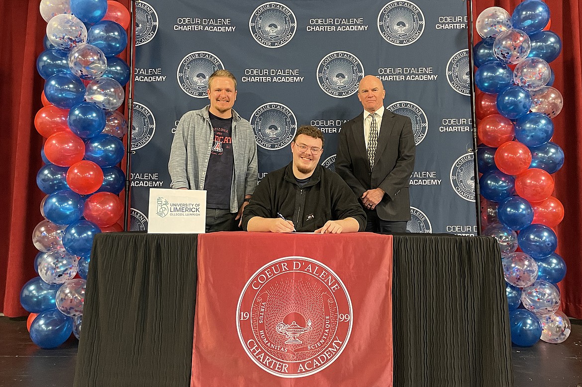 Coeur d'Alene Charter Academy senior Shire Engle signed a letter of intent to attend the University of Limerick in Limerick, Ireland. Pictured is Charter band director Michael Harrison, Shire Principal Dan Nicklay.