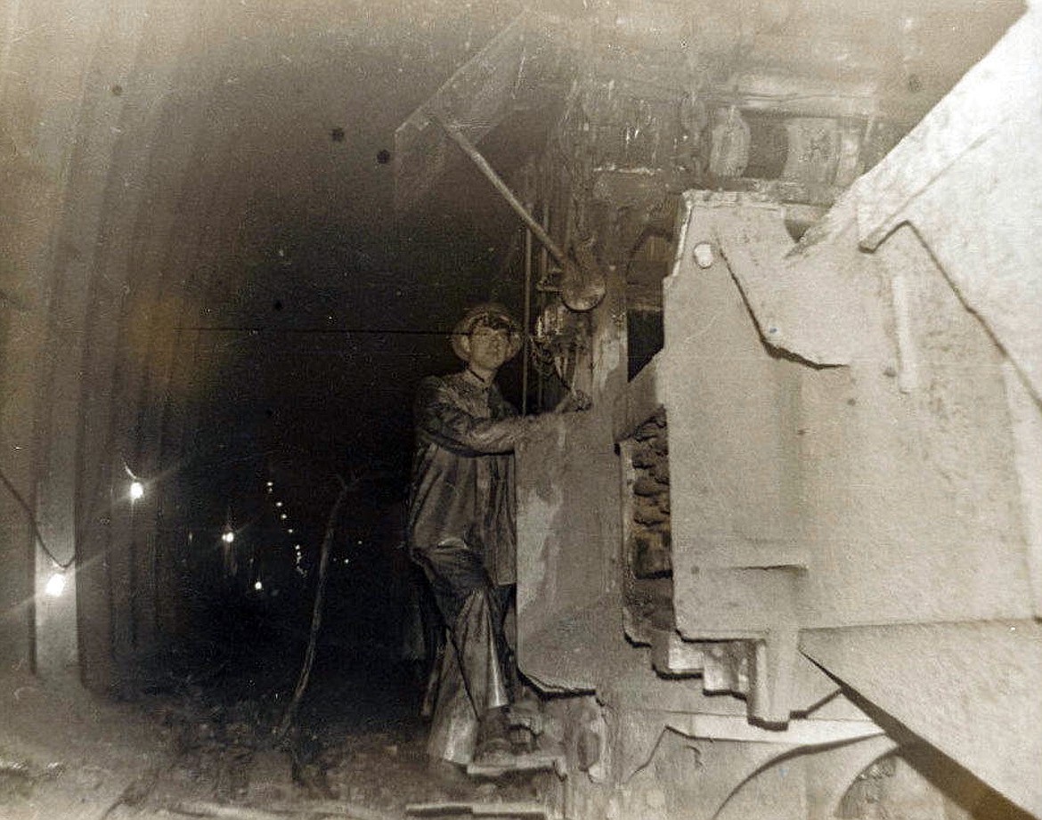 A 19-year-old Bruce Morse operating the mucking machine to clear debris from the construction of the Flathead Tunnel. (photo provided)