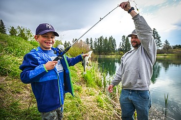 Costin Banning holds a rainbow trout he reeled in with his father Byron at the Brooke Hanson Memorial Family Fishing Day at Pine Grove Pond on Saturday, May 21. Hundreds of prizes were donated by area merchants and sportsmen's groups to be awarded to kids 12 and under. The event was sponsored by Flathead Wildlife and donations go to enhancing fishing opportunities around the Flathead in Brooke Hanson's memory. (Casey Kreider/Daily Inter Lake)